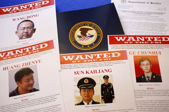 Press materials are displayed on a table of the Justice Department in Washington, Monday, May 19, 2014, before Attorney General Eric Holder was to speak at a news conference. Holder was announcing that a U.S. grand jury has charged five Chinese hackers with economic espionage and trade secret theft, the first-of-its-kind criminal charges against Chinese military officials in an international cyber-espionage case.
