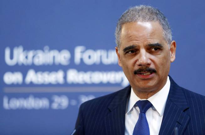 In this April 29, 2014, file photo, U.S. Attorney General Eric Holder speaks at the Ukraine Forum on Asset Recovery in central London.