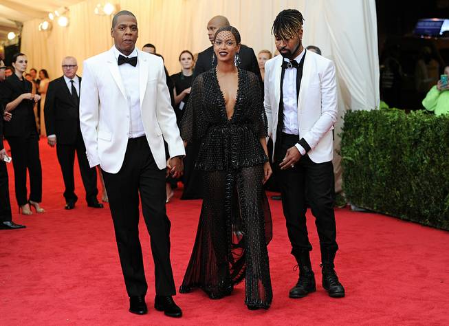 In this Monday, May 5, 2014, photo, Jay Z and Beyonce arrive at the Metropolitan Museum of Art's Costume Institute benefit gala celebrating "Charles James: Beyond Fashion" in New York. 
