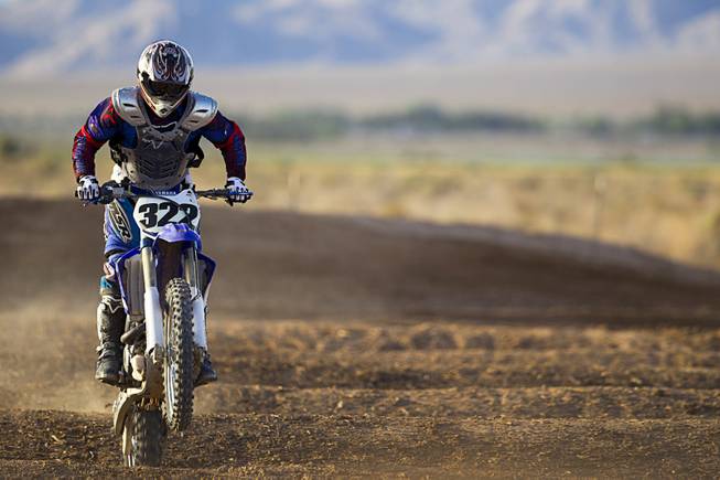 Randy Wattles, 49, of Summerlin goes through whoop-de-doos at the Sandy Valley MX motocross course in Sandy Valley Thursday, May 15, 2014.