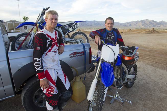 Ryan Phillips, 20, left, and Randy Wattles, 49, wait as the course is being groomed at the Sandy Valley MX motocross course in Sandy Valley Thursday, May 15, 2014.