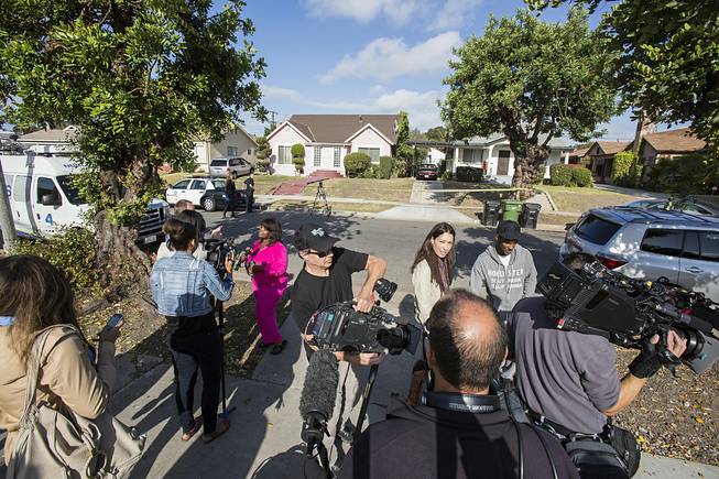 Neighbors are interviewed by media in front of the home of actor Michael Jace on Tuesday, May 20, 2014, in Los Angeles. 