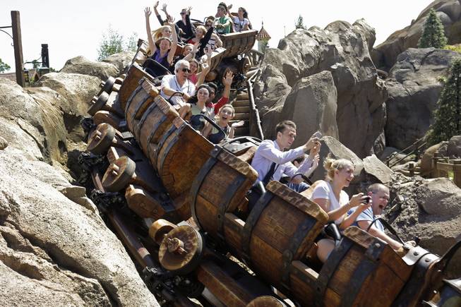 This May 16, 2014, photo shows Disney cast members testing the new Seven Dwarfs Mine Train roller coaster in the Magic Kingdom at Walt Disney World in Lake Buena Vista, Fla. The ride will be opened to park guests May 28.