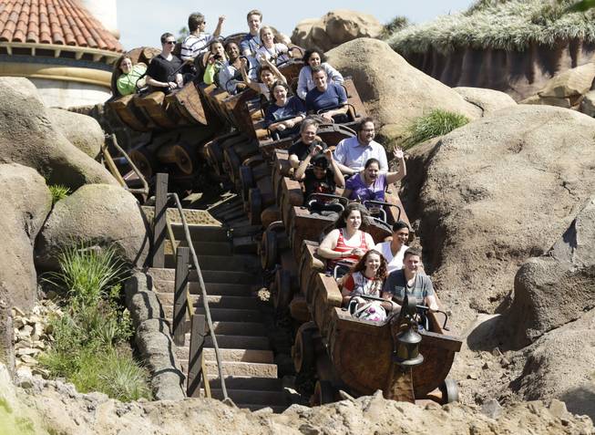 This May 16, 2014, photo shows Disney cast members testing the new Seven Dwarfs Mine Train roller coaster in the Magic Kingdom at Walt Disney World in Lake Buena Vista, Fla. The ride will be opened to park guests May 28.