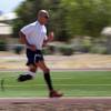 Mstr. Sgt. Christopher Aguilera runs at the outdoor track at Nellis Air Force Base Wednesday, May 21, 2014. Aguilera was selected as one of 40 Air Force members to participate in the 2014 London Invictus Games for wounded veterans. Aguilera was injured when his helicopter was shot down in Afghanistan in 2010.
