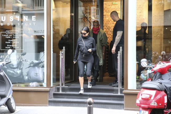 Kim Kardashian and U.S rap singer Kanye West leave a fitness center in Paris, Wednesday, May 21, 2014. The gates of the Chateau de Versailles, once the digs of Louis XIV, will be thrown open to Kim Kardashian, Kanye West and their guests for a private evening this week ahead of their marriage.