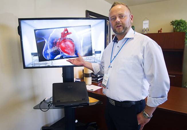 Sensavis CEO Fredrik Olofsson shows off no-glasses 3D technology before a demonstration of Sensavis 3D educational software in Las Vegas Wednesday, May 21, 2014. Sensavis, a Swedish education company, is promoting their "3D classroom," which allows students to interact with subjects like human anatomy, math, science and geography in a realistic virtual environment.