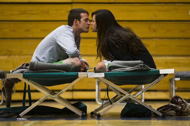 Nathan Westerfield, 22, kisses his new bride, Mickella, 20, at the Red Cross shelter set up at Sinagua Middle School in Flagstaff, Ariz., Tuesday, May 20, 2014. 