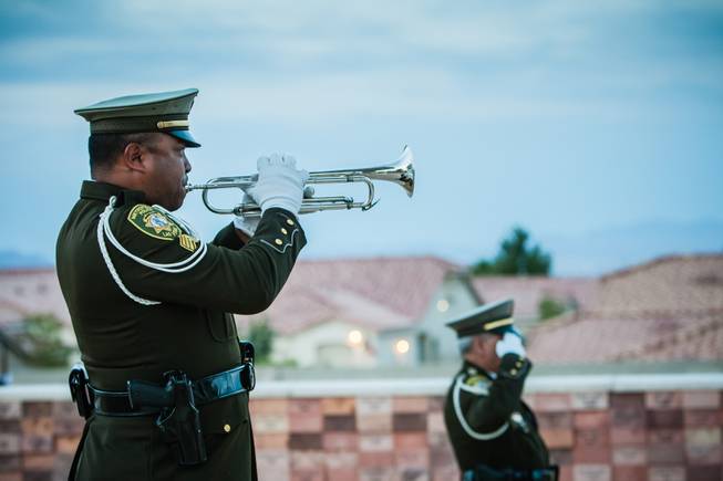 Taps sounds through the air in honor of Nevada fallen officers during the Southern Nevada Law Enforcement Memorial ceremony at Police Memorial Park in Las Vegas Thursday, May 22, 2014.