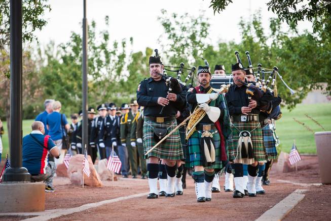 The Nevada Law Enforcement Honor Guard leads the march of honor for the families of fallen officers during the Southern Nevada Law Enforcement Memorial ceremony at Police Memorial Park in Las Vegas Thursday, May 22, 2014.