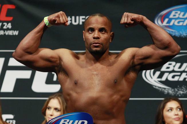 Daniel Cormier flexes on the scale during the weigh in for UFC 173 Friday, May 23, 2014 at the MGM Grand Garden Arena.