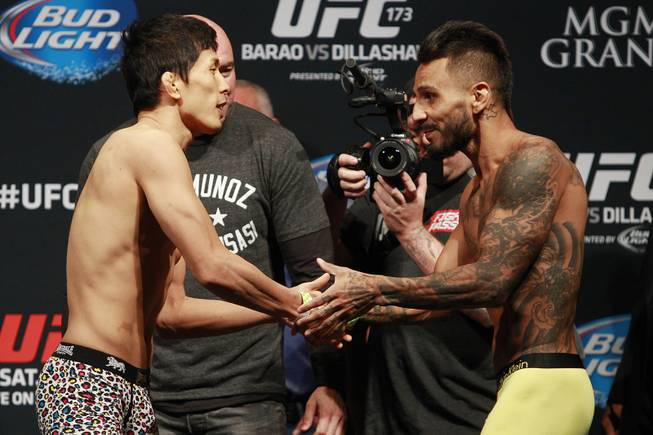 Takeya Mizugaki and Francisco Rivera shake hands during the weigh in for UFC 173 Friday, May 23, 2014 at the MGM Grand Garden Arena.