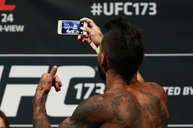 Francisco Rivera takes a selfie after making weight during the weigh in for UFC 173 Friday, May 23, 2014 at the MGM Grand Garden Arena.