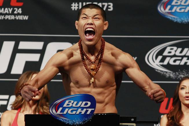 Li JingLiang reacts to making weight during the weigh in for UFC 173 Friday, May 23, 2014 at the MGM Grand Garden Arena.