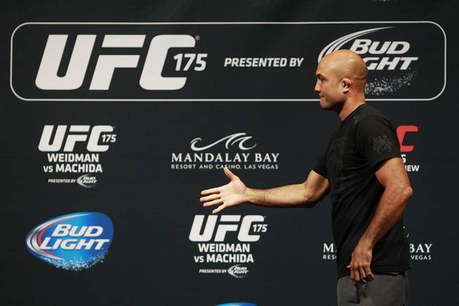 B.J. Penn pretends to shake the hand of missing Frankie Edgar during a news conference to promote UFC 175 on Friday, May 23, 2014, at the MGM Grand Garden Arena. Edgar missed the news conference to be with his wife during the birth of their child. UFC 175 is July 5, 2014, at the Mandalay Bay Events Center.