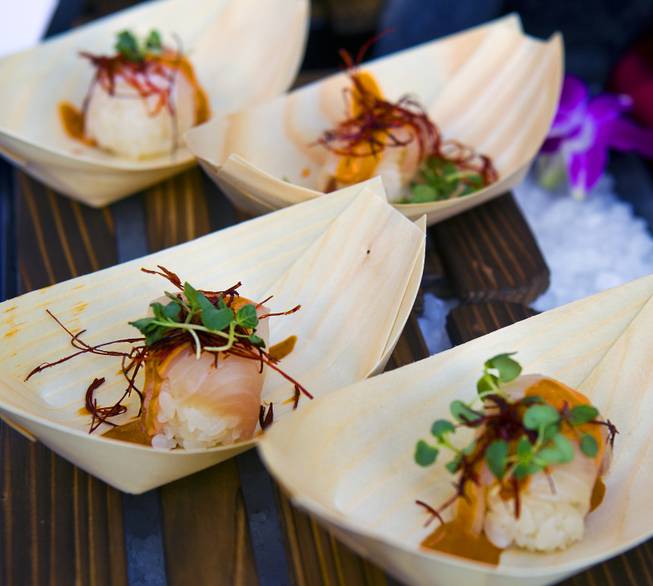 Sushi samba serves a yellowtail sushi with lemongrass sauce during the annual showcase of nearly 75 of Las Vegas finest restaurants, nightclubs and beverage purveyors on Thursday, May 22, 2014.