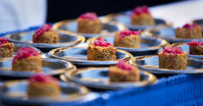 Canonita serves a quinoa fritter with goat cheese, pickled onion and rocoto sauce during the Epicurean Affair presented by the Nevada Restaurant Association at the Palazzo on Thursday, May 22, 2014.