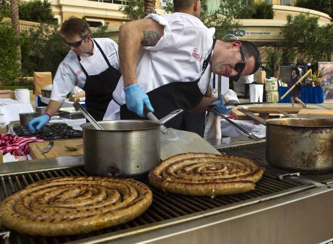 Christian Gonzalez with Buddy V's checks on the readiness of a homemade Italian sausage during the Epicurean Affair presented by the Nevada Restaurant Association at the Palazzo on Thursday, May 22, 2014.