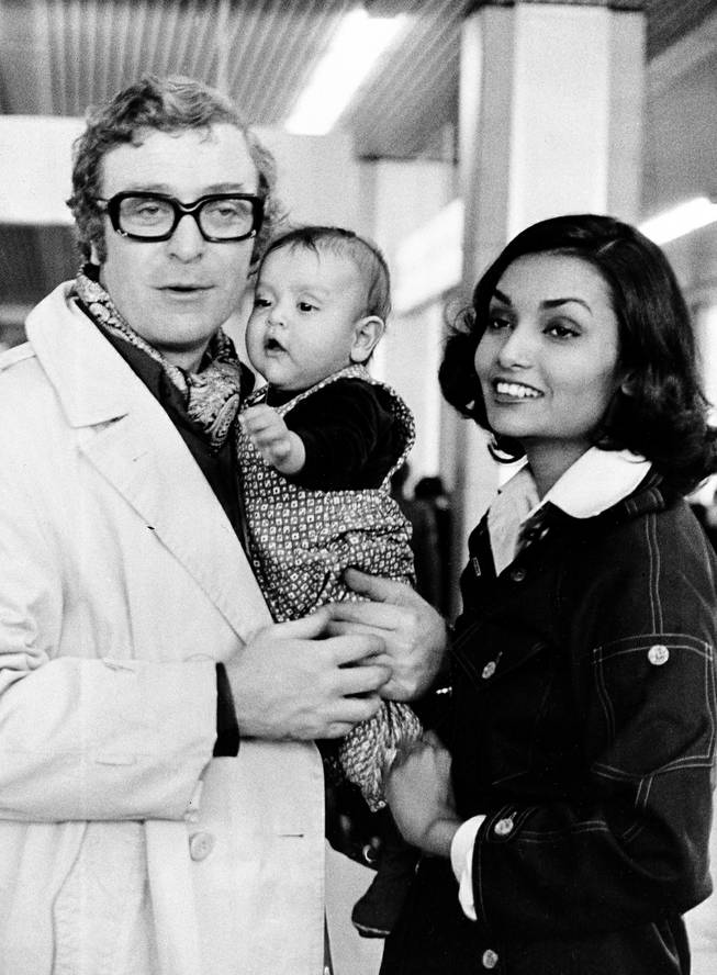 British actor Michael Caine is shown with his wife Shakira and their 5-month-old daughter Natasha at Nice Airport, France, Dec. 26, 1973. 