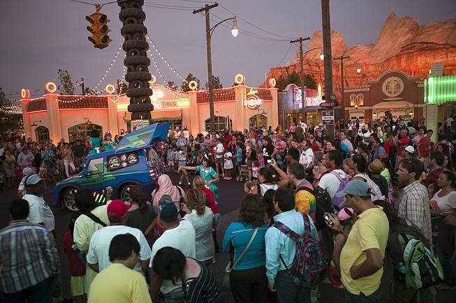 Guests watch DJ's Dance 'n Drive show in Cars Land at Disney California Adventure Park in Anaheim, Calif., June 8, 2012. 