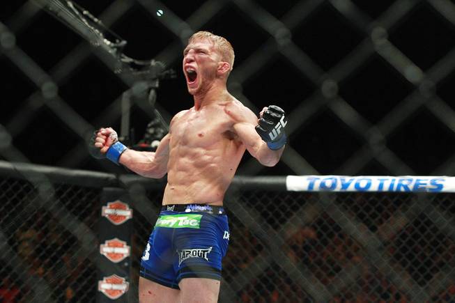 T.J. Dillashaw celebrates his fifth round TKO upset of Renan Barao in their bantamweight title fight at UFC 173 Saturday, May 24, 2014 at the MGM Grand Garden Arena.