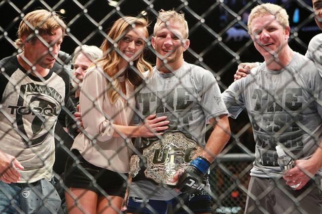 T.J. Dillashaw poses for photos after his upset TKO victory over Renan Barao in their bantamweight title fight at UFC 173 Saturday, May 24, 2014 at the MGM Grand Garden Arena.