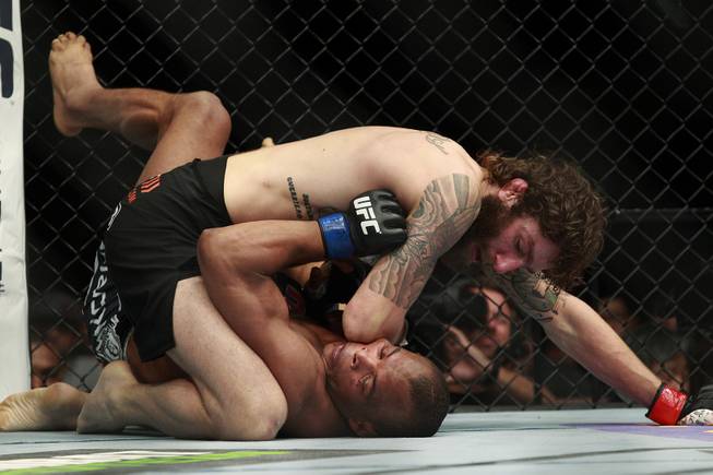 Lightweight Michael Chiesa drops an elbow onto the face of Francisco Trinaldo during their fight at UFC 173 Saturday, May 24, 2014 at the MGM Grand Garden Arena. Chiesa won a unanimous decision.