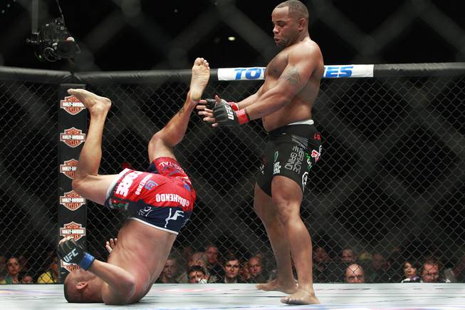 Daniel Cormier leaps back from Dan Henderson during their fight at UFC 173 Saturday, May 24, 2014 at the MGM Grand Garden Arena. Cormier won with a rear naked choke in the third round.