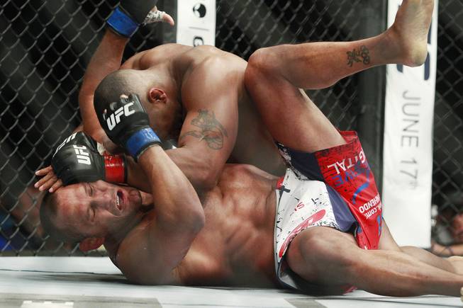 Daniel Cormier hits Dan Henderson with a left during their fight at UFC 173 Saturday, May 24, 2014 at the MGM Grand Garden Arena. Cormier won with a rear naked choke in the third round.