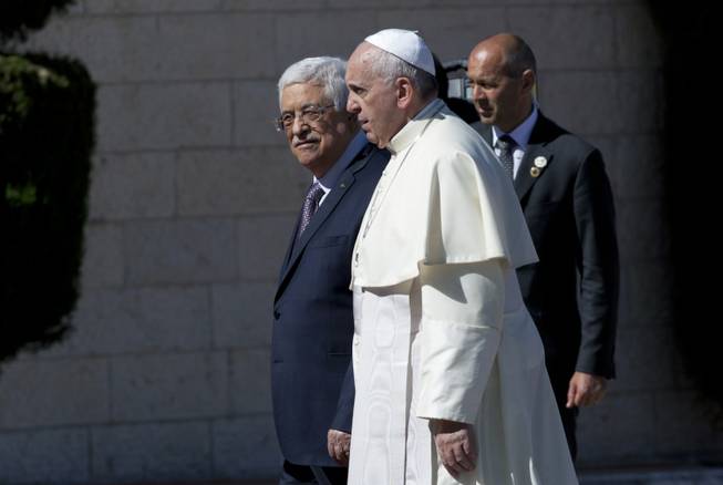 Palestinian President Mahmoud Abbas, left, receives Pope Francis upon his arrival at the Palestinian Authority headquarters in the West Bank city of Bethlehem on Sunday, May 25, 2014. Francis landed Sunday in the West Bank town of Bethlehem in a symbolic nod to Palestinian aspirations for their own state as he began a busy second day of his Mideast pilgrimage.