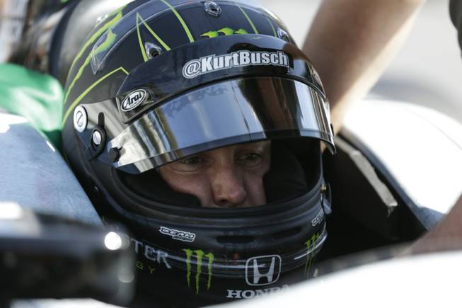 Race driver Kurt Busch practices at the Indianapolis Motor Speedway during the Rookie Orientation Program in Indianapolis, Tuesday, April 29, 2014. Busch will try to be the first driver in a decade to compete in IndyCar's Indianapolis 500 and Sprint Cup's Coca-Cola 600 on the same day.