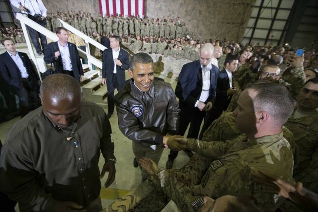 President Barack Obama shakes hands at a troop rally at Bagram Air Field, north of Kabul, Afghanistan, during an unannounced visit, on Sunday, May 25, 2014.