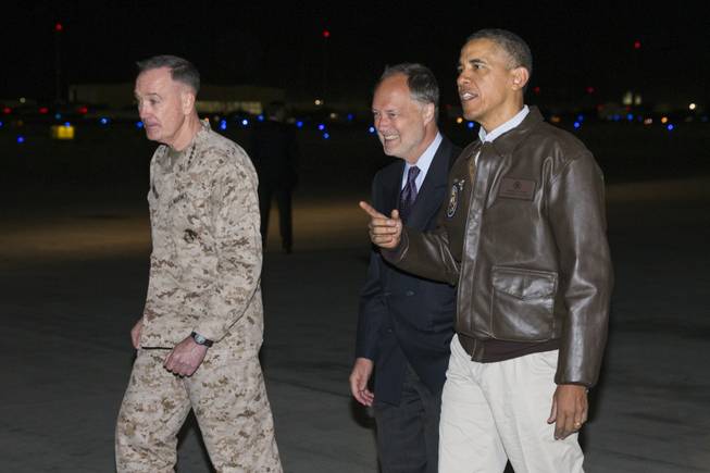 President Barack Obama, right, is greeted by U.S. Ambassador to Afghanistan James Cunningham, center, and Marine General Joseph Dunford, commander of the US-led International Security Assistance Force (ISAF), as he arrives at Bagram Air Field for an unannounced visit, on Sunday, May 25, 2014, north of Kabul, Afghanistan.
