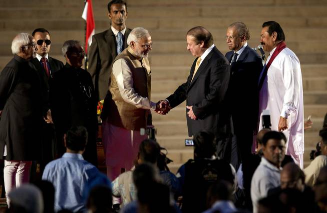 India’s new prime minister Narendra Modi, center left, shakes hands with his Pakistani counterpart Nawaz Sharif, as Sri Lankan President Mahinda Rajapaksa, right, and Mauritius Prime Minister Navinchandra Ramgoolam, second right watch during Modi’s inauguration in New Delhi, India, Monday, May 26, 2014. Modi took the oath of office as India's new prime minister at the sprawling presidential palace on Monday, a moment made more historic by the presence of the leader of archrival Pakistan. Indian President Pranab Mukherjee, third left and Indian Vice President Hamid Ansari, left, are also seen.