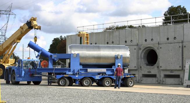 In this Oct. 14, 2010 photo released by Dominion Resources, a trailer holding a spent fuel storage container is maneuvered into position for offloading into a horizontal storage module at the Millstone Power Station in Waterford, Conn. With the collapse of a proposal for nuclear waste storage at Nevada’s Yucca Mountain, Millstone and other plants across the country are building or expanding on-site storage for waste.
