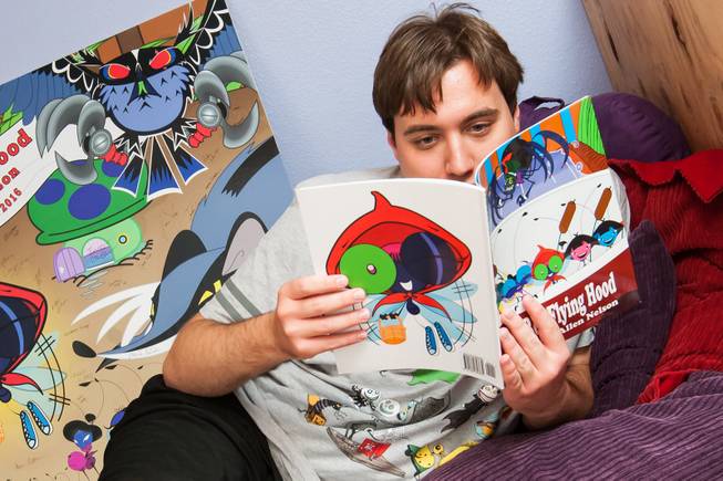 Author Ben Nelson, 20, enjoys reading his first published work "Little Red Flying Hood" while relaxing at his home in Henderson May 23, 2014.