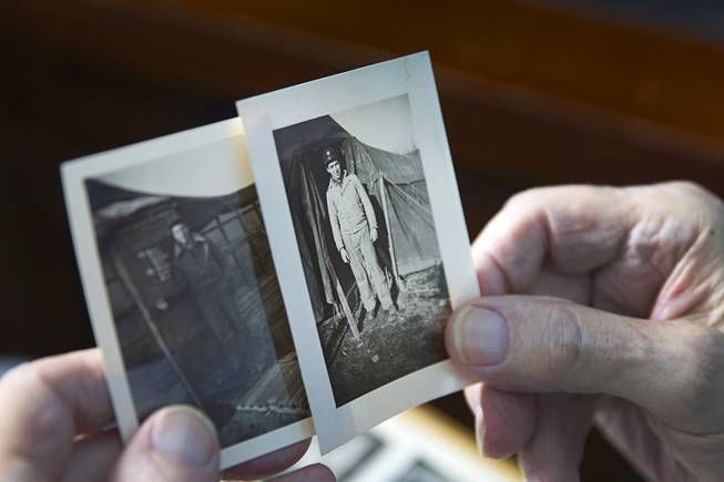 World War II veteran Davis B. Leonard holds a photo of himself at his home in Henderson Wednesday, May 28, 2014. The photo was taken at the Laon-Athies Air Base in France in 1944, he said. Leonard and Gaetano "Guy" Benza, another local World War II veteran, will receive the French Legion d'Honneur award on Friday. The award is the highest honor France bestows on its citizens and foreign nationals.
