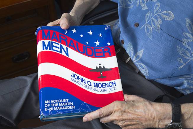 World War II veteran Davis B. Leonard holds a book about the Marauder crews at his home in Henderson Wednesday, May 28, 2014. Leonard flew in the B-26 Marauders when served with the 323d Bombardment Group, 9th Air Force. Leonard and Gaetano "Guy" Benza, another local World War II veteran, will receive the French Legion d'Honneur award on Friday. The award is the highest honor France bestows on its citizens and foreign nationals.