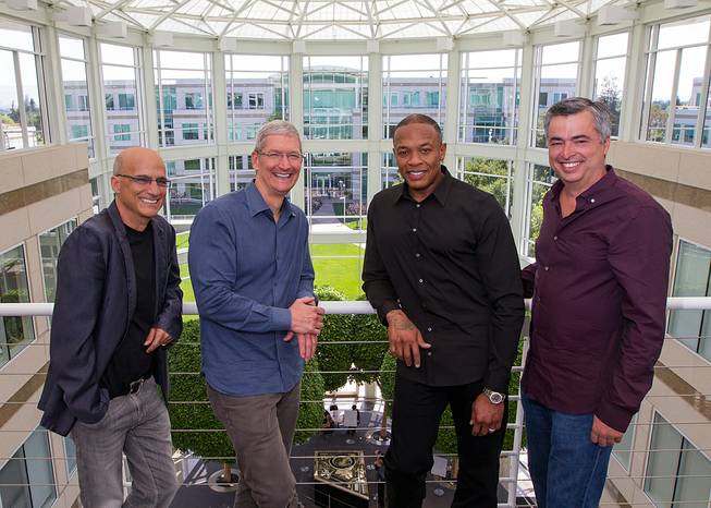 In this image provided by Apple, music entrepreneur and Beats co-founder Jimmy Iovine, Apple CEO Tim Cook, Beats co-founder Dr. Dre and Apple Senior Vice President Eddy Cue are at Apple headquarters in Cupertino, Calif., on Wednesday, May 28, 2014. 