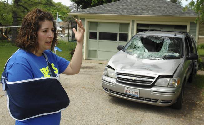 In this Tuesday, May 27, 2014, photo, Heidi Conner of West Dundee, Ill., describes how a 200-pound deer leaped from an overpass and landed on her minivan as her four children and she traveled along an Illinois interstate Sunday. Conner says the accident totaled the van and caused minor injuries.