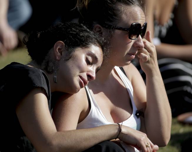 Students cry during a memorial service for the victims and families of Friday's rampage at Harder Stadium on the campus of University of California, Santa Barbara on Tuesday, May 27, 2014, in the Isla Vista area near Goleta, Calif. 