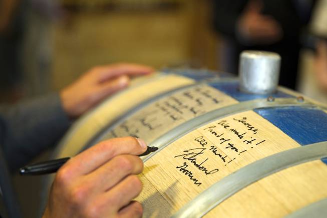 Nevada Governor Brian Sandoval signs the "Governor's Barrel" at the Las Vegas Distillery in Henderson Thursday, May 29, 2014. Governor Sandoval helped fill the first bottle of "Nevada 150," a bourbon whiskey created for the Nevada sesquicentennial.