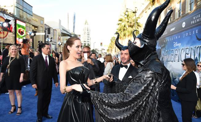 Angelina Jolie, right, arrives at the world premiere of "Maleficent" at the El Capitan Theatre on Wednesday, May 28, 2014, in Los Angeles. 
