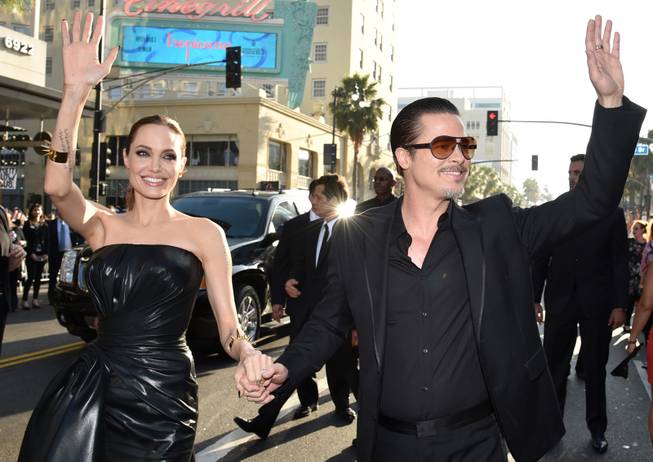 Angelina Jolie and Brad Pitt arrive at the world premiere of her new film "Maleficent" at El Capitan Theater on Wednesday, May 28, 2014, in Los Angeles. 