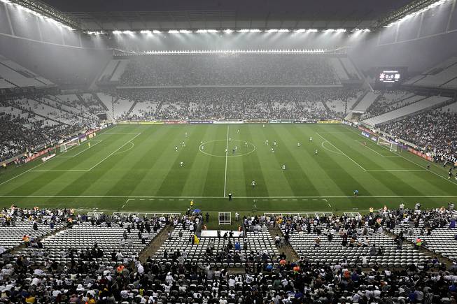 Corinthians's and Figueirense players battle it out during a Brazilian soccer league match at the Itaquerao, the still unfinished stadium that will host the World Cup opener match between Brazil and Croatia on June 12, in Sao Paulo, Brazil, Sunday, May 18, 2014. Only 40,000 tickets were put on sale for Corinthians' match against Figueirense because some of the 20,000 temporary seats needed for the World Cup opener are still being installed. 
