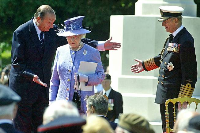 In this June 6, 2004, file photo, French President Jacques Chirac, left, greets Queen Elizabeth II, of Britain, and her husband Prince Philip at the British military cemetery in Bayeux, northwestern France, during ceremonies marking the 60th anniversary of the D-Day landings in Normandy. 