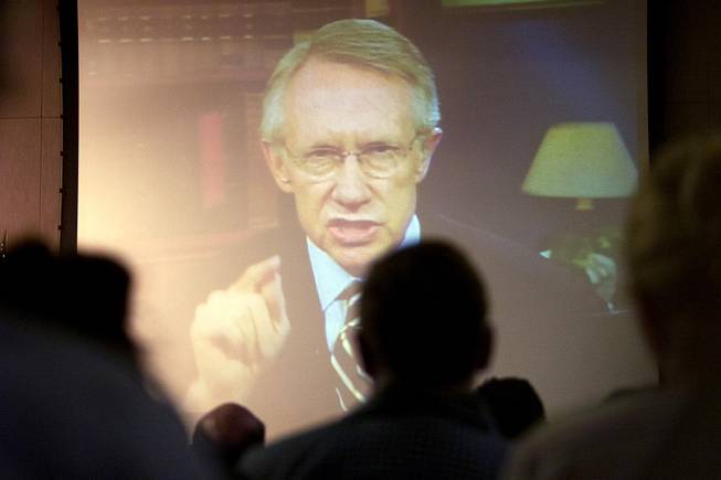Via satellite from Washington D.C., Sen. Harry Reid addresses representatives from the Department of Energy during the DoE's public hearing on the proposed Yucca Mountain Repository Sept. 5, 2001.