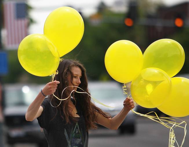 Rachel Malone, 17, ties balloons along Main Street in Hailey, Idaho on Saturday, May 31, 2014 after the announcement that U.S. Army Sgt. Bowe Bergdahl has been released from captivity. Bergdahl, 28, had been held prisoner by the Taliban since June 30, 2009. He was handed over to U.S. special forces by the Taliban in exchange for the release of five Afghan detainees held by the United States. (AP Photo/The Times-News, Drew Nash)