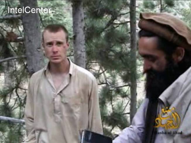 This file image provided by IntelCenter on Dec. 8, 2010, shows a frame grab from a video released by the Taliban containing footage of a man believed to be Bowe Bergdahl, left.  Saturday, May 31, 2014, U.S. officials say Bergdahl, the only American soldier held prisoner in Afghanistan has been freed and is in U.S. custody. The officials say his release was part of a negotiation that includes the release of five Afghan detainees held in the U.S. prison at Guantanamo Bay, Cuba. (AP Photo/IntelCenter, File)