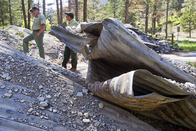 James Hurja, left, a USFS soil scientist and burn response coordinator for Mt. Charleston, and Ron Bollier, a USFS fire management officer, stand by a washed-out bridge near Forest Service administrative offices is shown on Mt. Charleston Tuesday, May 27, 2014. The bridge was destroyed by run-off after the Carpenter 1 Fire in 2013.